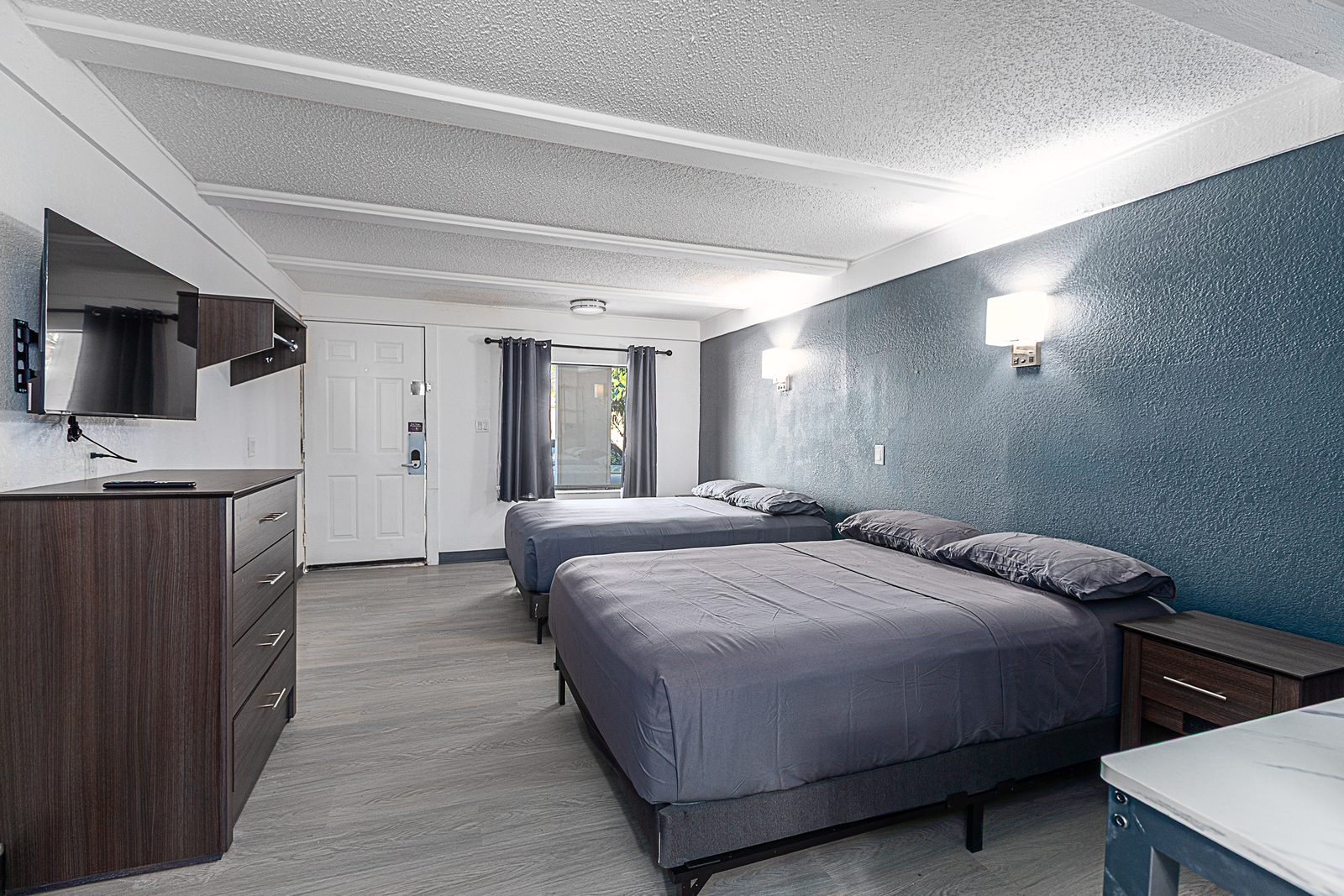 Studio with two beds, dresser and TV